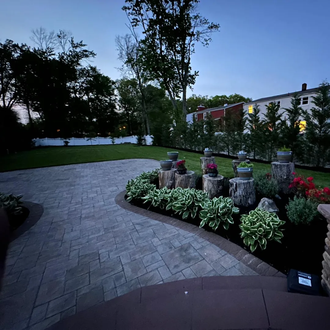 Beautiful backyard patio with lush landscaping and trees.